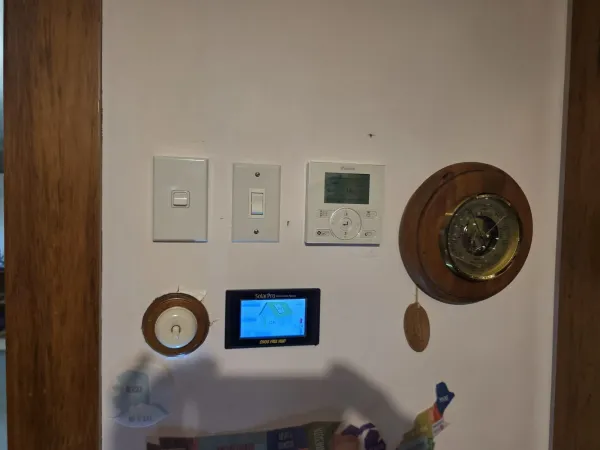 Ducted system wall controller mounted in a hallway beside a light switch