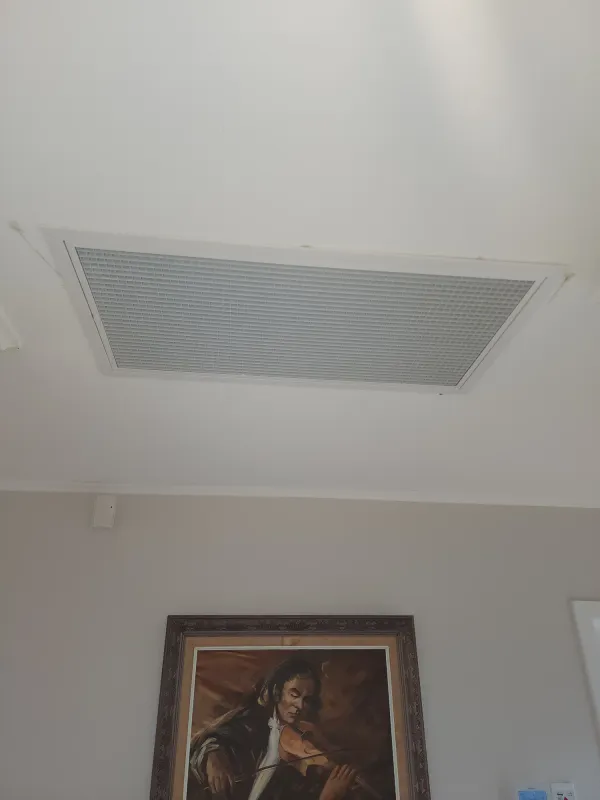 Round ceiling diffuser supplying warm air into a living area