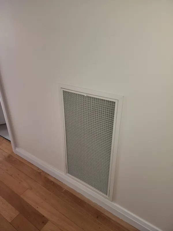 Round ceiling diffuser set into a bedroom ceiling