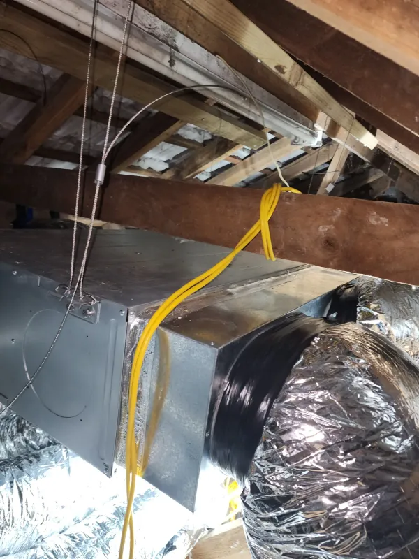 Ducted heat pump indoor unit suspended in a roof space with insulation below