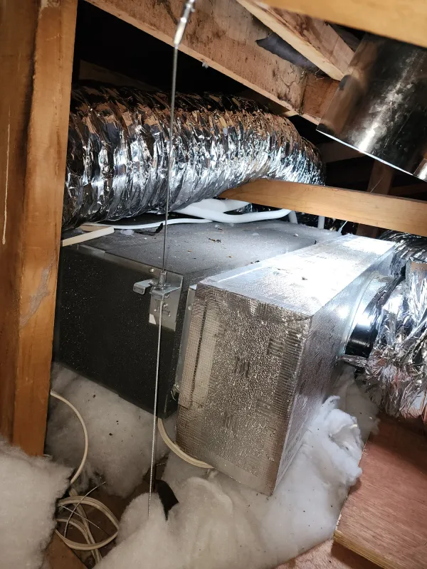 Ducted indoor unit mounted above the ceiling with supporting straps