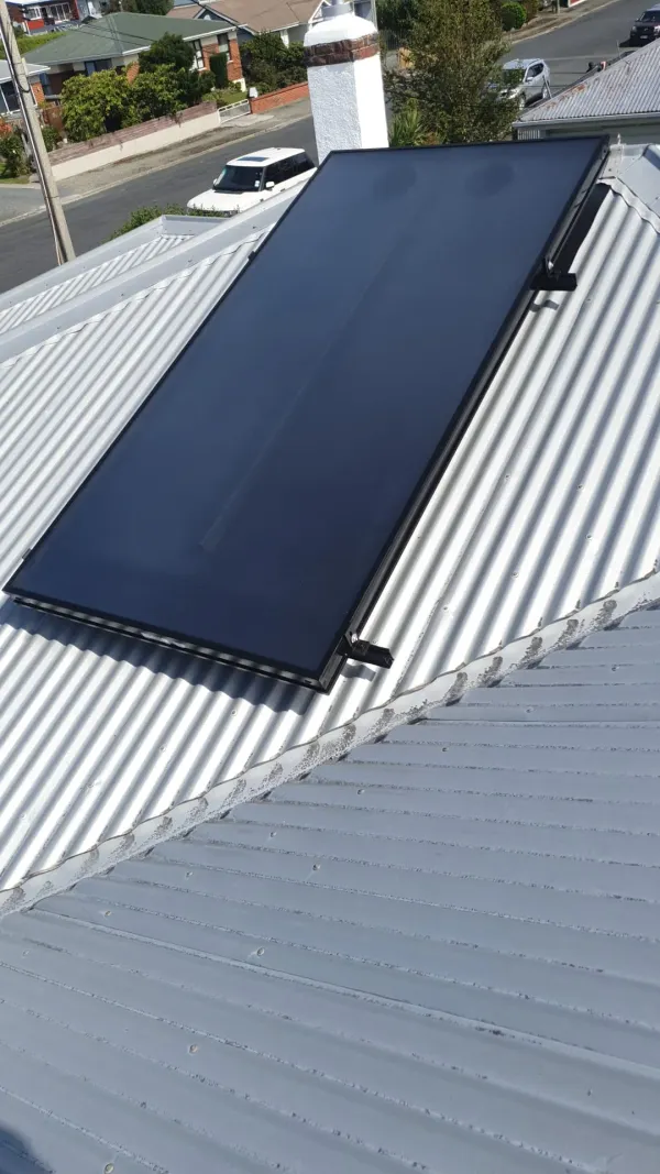 Solar air panel on a steep roof pitch feeding a ducted heating system