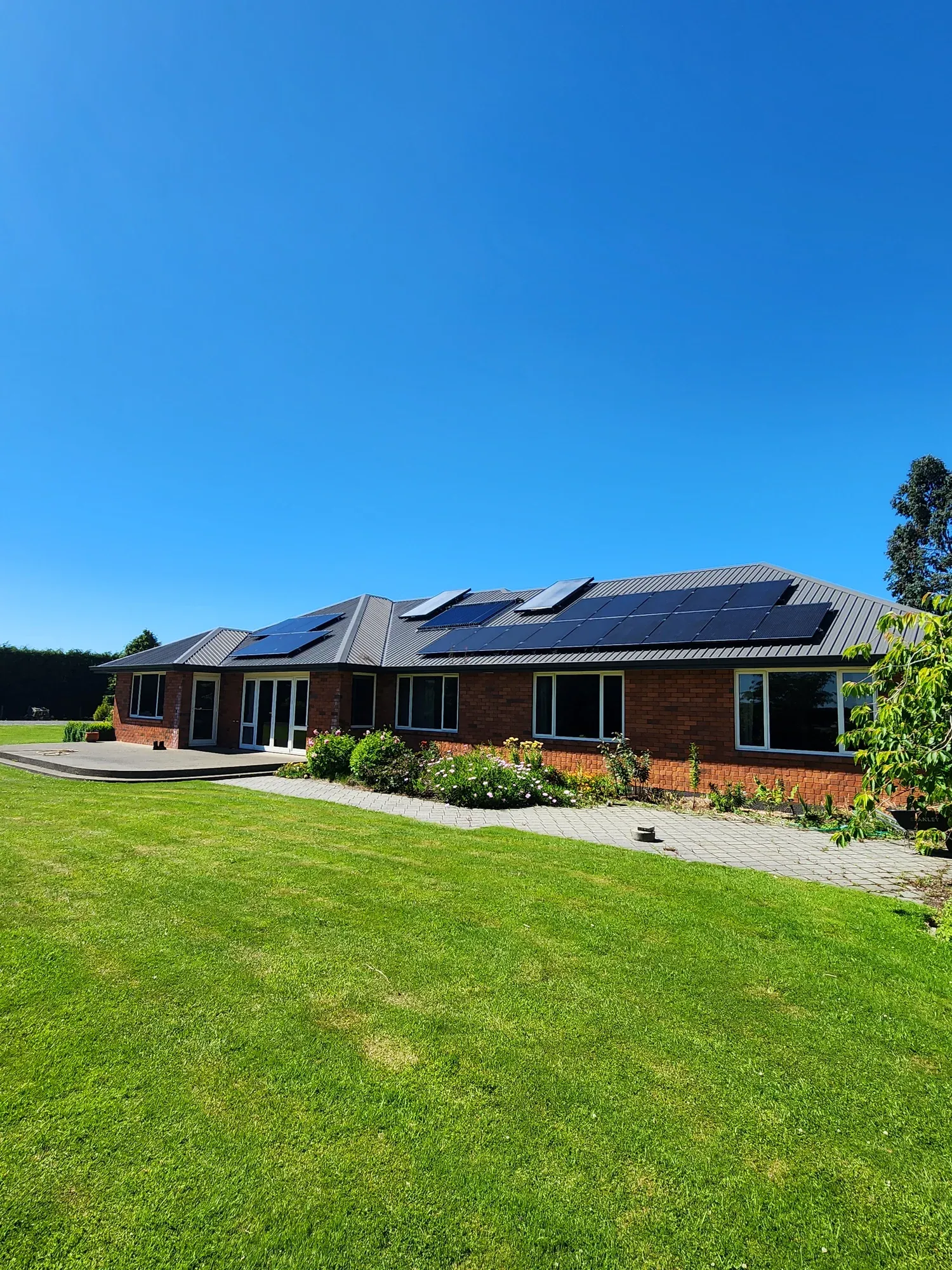 A completed home with solar air collectors on the roof