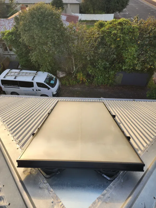 Glass solar air panel between the ribs of a pale coloursteel roof