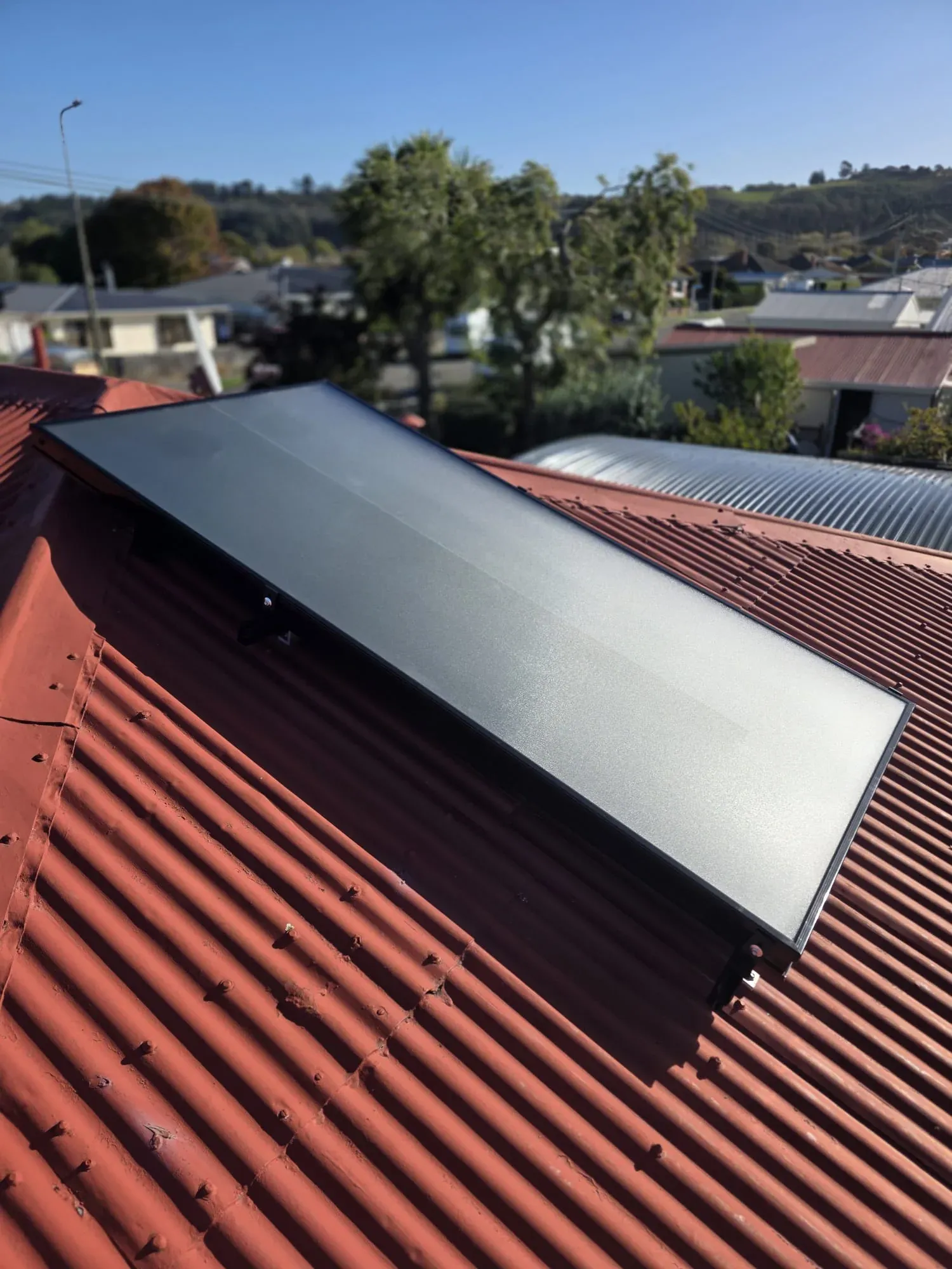 Solar air panel on a red tiled roof