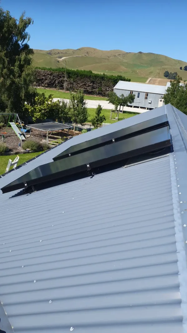 Close view of a solar air panel frame sealed into a corrugated roof