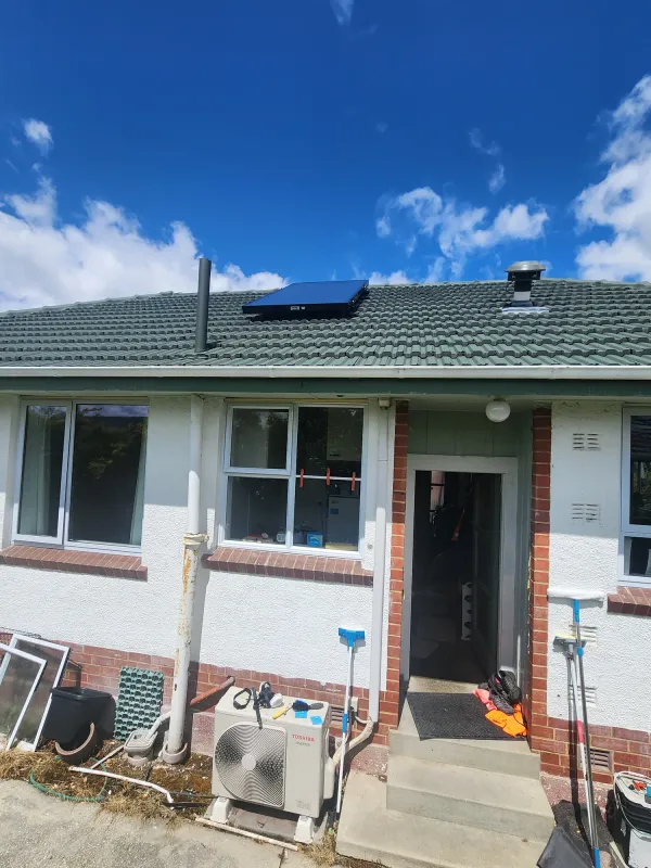 Solar air panel on a grey corrugated roof in full sun